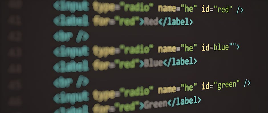 Close-up of a computer screen displaying HTML code with color-coded tags and attributes, including 'type', 'name', and 'id', used for website development. The code appears blurred but the different co